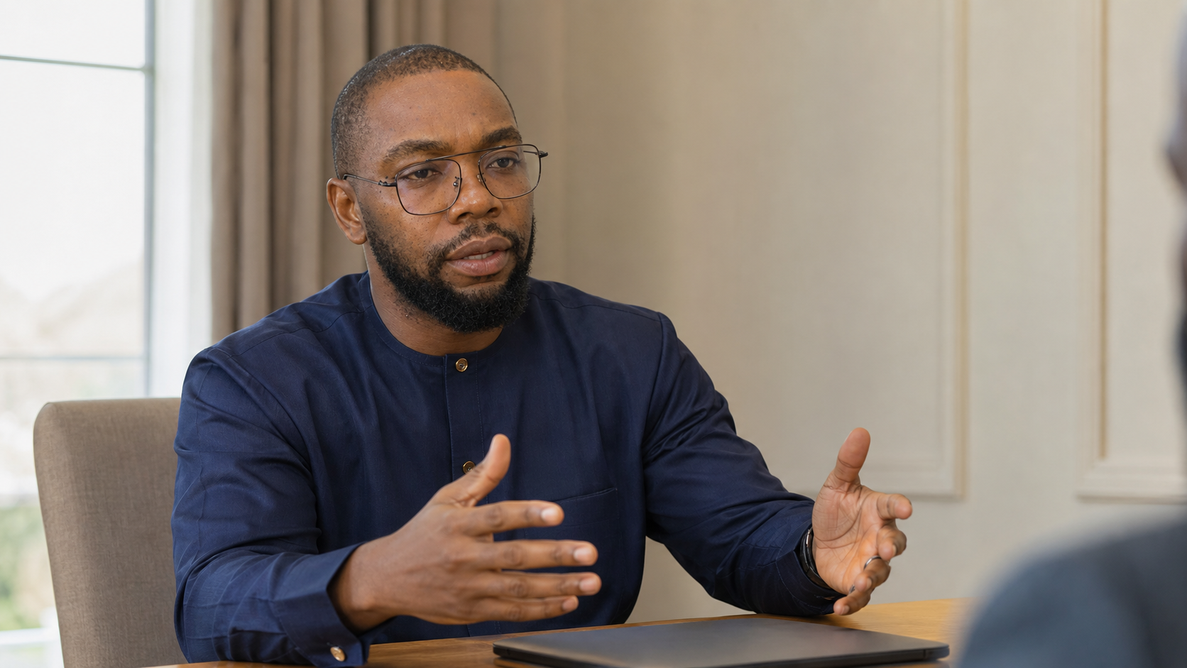 Christiano Ifesi speaking with an executive